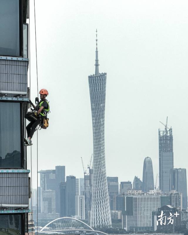 楼面灯光维护人员从高楼顶部一跃而下，在120米高空拆装灯光设备。